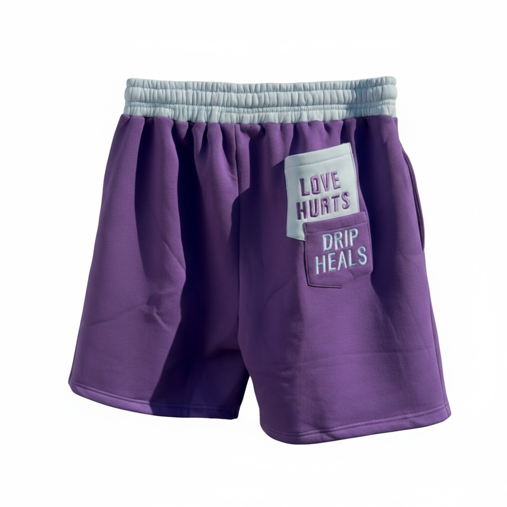 Back of Purple shorts with stack pockets that says love hurts drips heals on white background