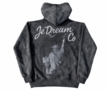 Black acid wash hoodie with 'Je'Dream Co' branding and Statue of Liberty graphic on a white background