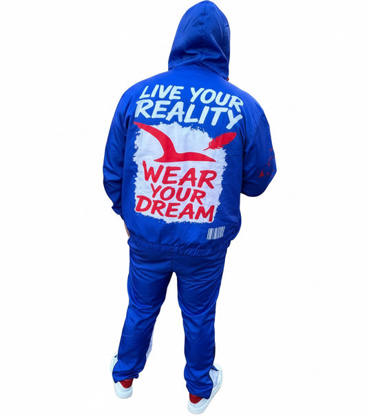 Person wearing a blue windbreaker with motivational text on a road.