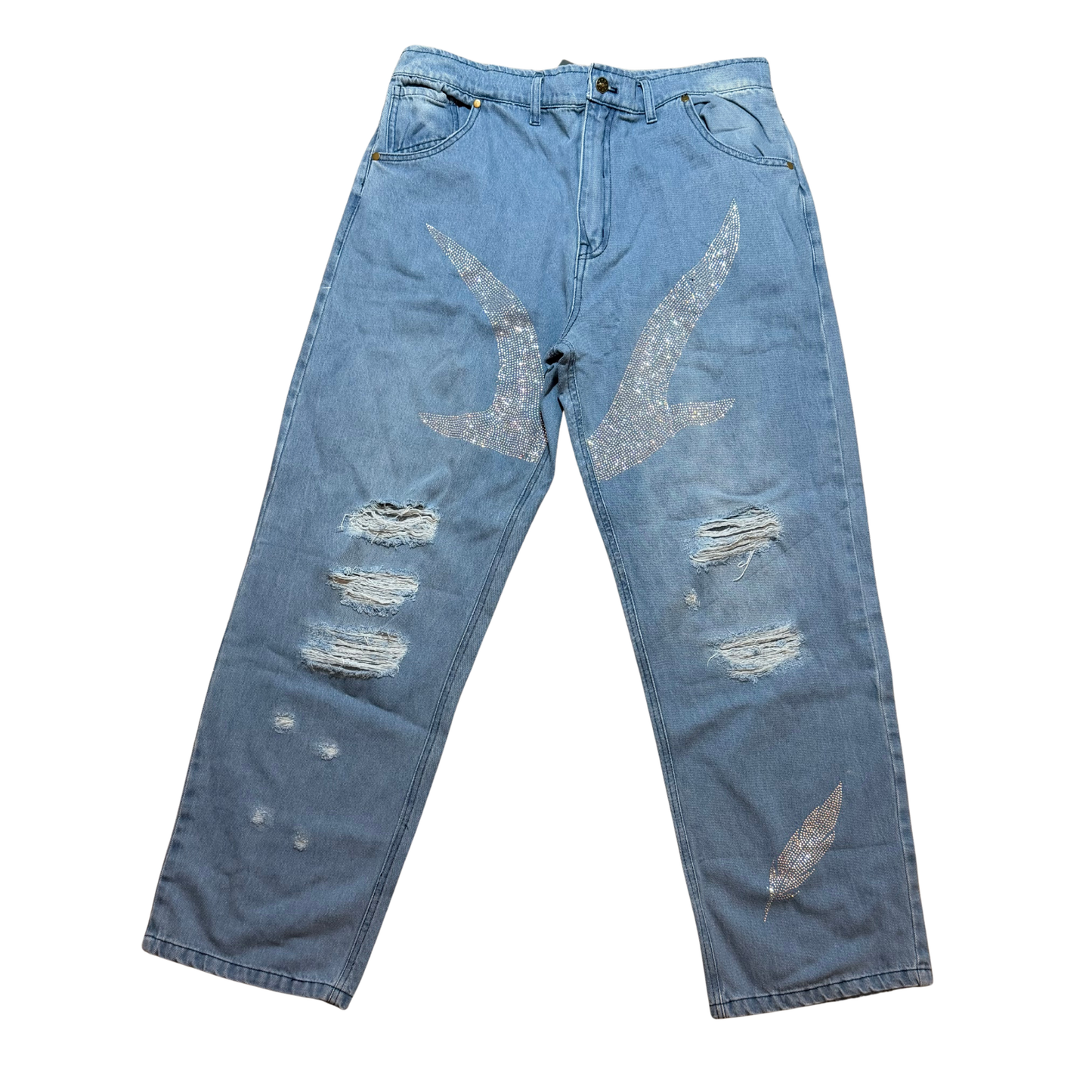 Blue denim jeans with bird and feather designs with rhinestones and distressing on a white background