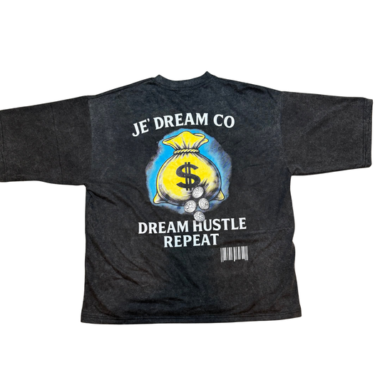 Black acid wash  graphic streetwear shirt by Je’ Dream Co featuring “Turn Your Pain Into Hustle” slogan, bold skull biker design, red flame backdrop, oversized fit, and premium cotton fabric for edgy urban fashion and motivational style.