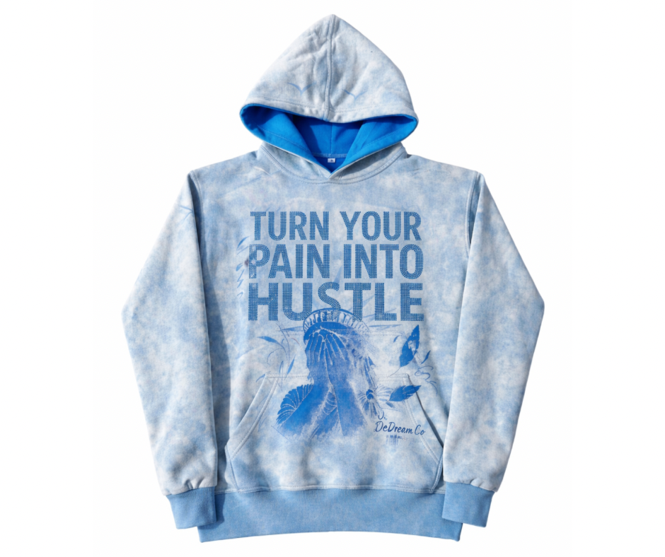 Light Blue acid wash hoodie with text 'Turn Your Pain Into Hustle' in rhinestones on a white background