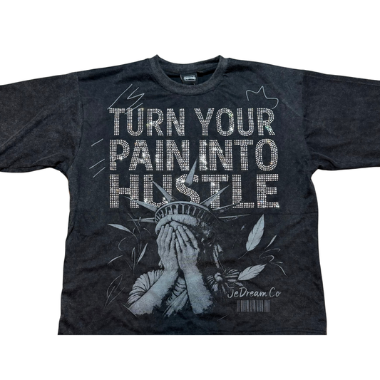 Black acid wash t-shirt with 'Turn Your Pain Into Hustle' text and a graphic design of face of Statue of Liberty on it in white background