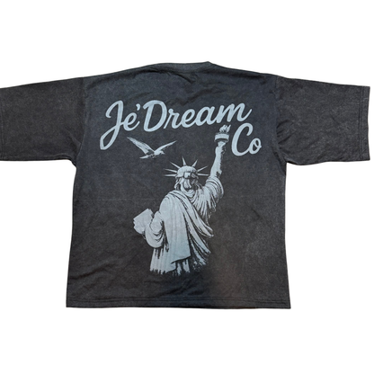 Black acid wash t-shirt with 'Je'Dream Co' and Statue of Liberty graphic on a white background