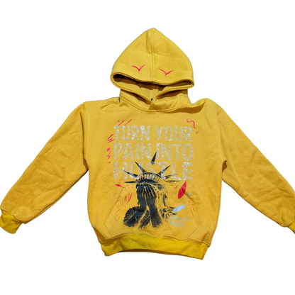 Yellow hoodie with rhinestones on front graphic design Statue of Liberty face and text on a white background