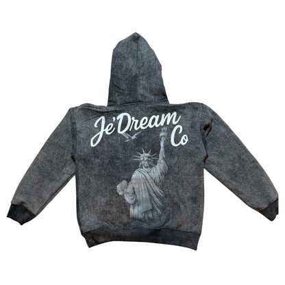 Black acid wash hoodie with je’ dream co on back and back view of Statue of Liberty in white background 
