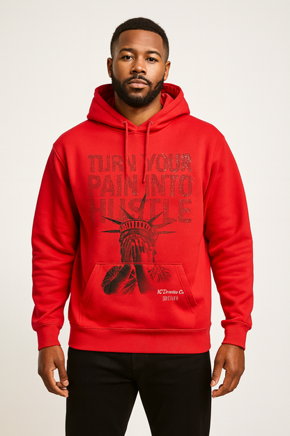 Man wearing a red hoodie with turn your pain into hustle in rhinestones and a graphic design on a white background