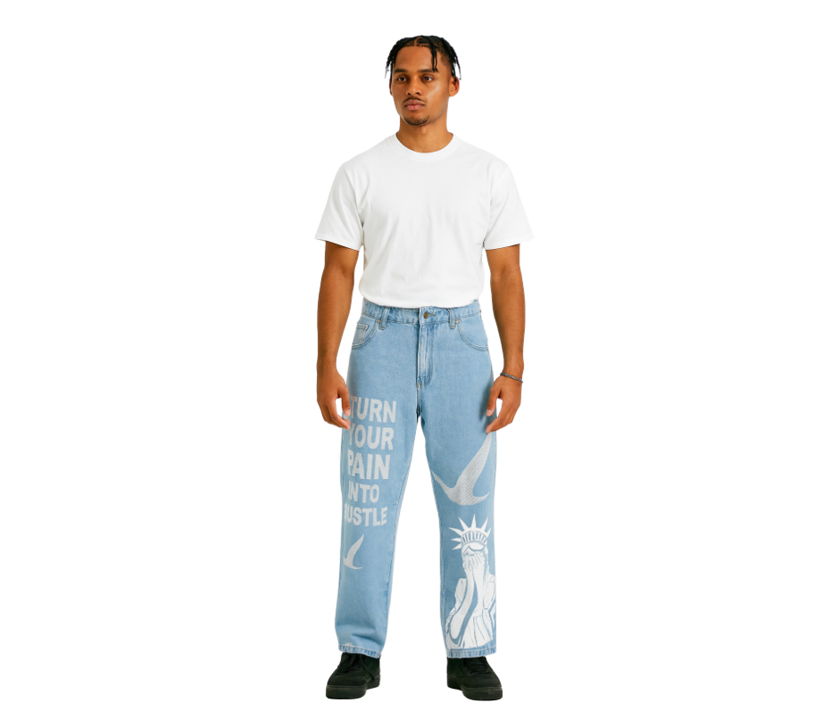 Person wearing our turn your pain into hustle light blue denim jeans with text and graphics birds symbol in rhinestone on a white background