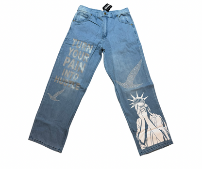 Turn your pain into hustle denim Blue jeans with artistic designs, 2 birds design in rhinestone and text on a white background
